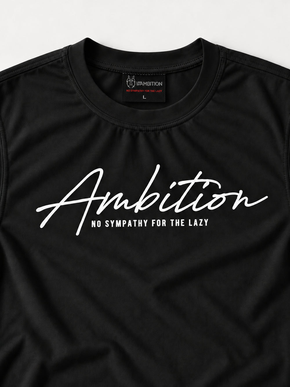 Close-up of the black Ambition T-shirt showing the chest print, small tagline, crew neckline and woven brand label.