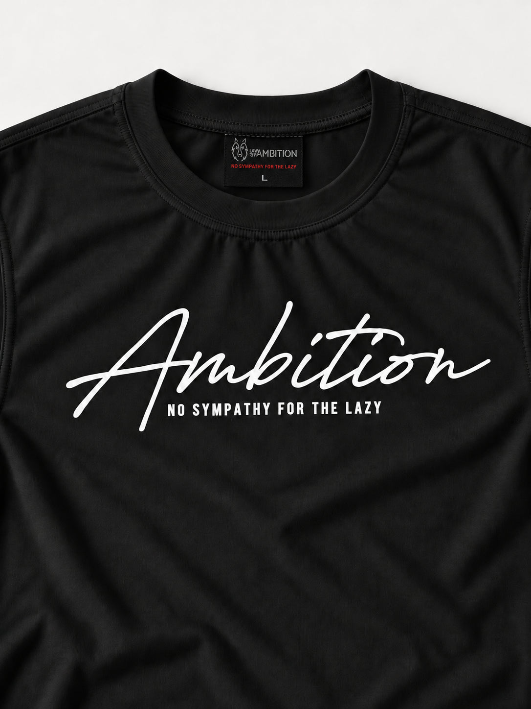 Close-up of the black Ambition T-shirt showing the chest print, small tagline, crew neckline and woven brand label.