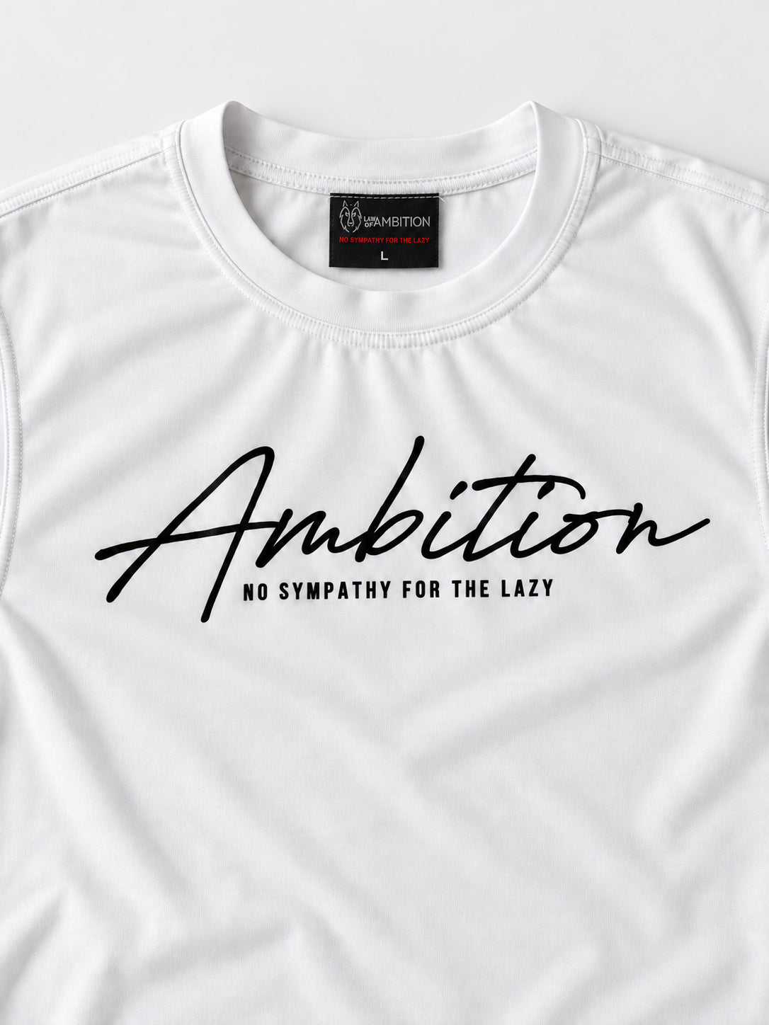 Close-up of the white Ambition T-shirt showing the chest print, small tagline, crew neckline and woven brand label.