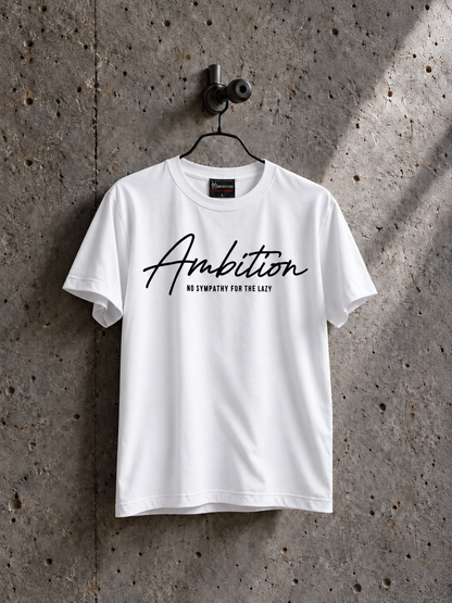 White Ambition T-shirt on a black hanger against textured concrete, with black chest lettering and a small sewn neck label.