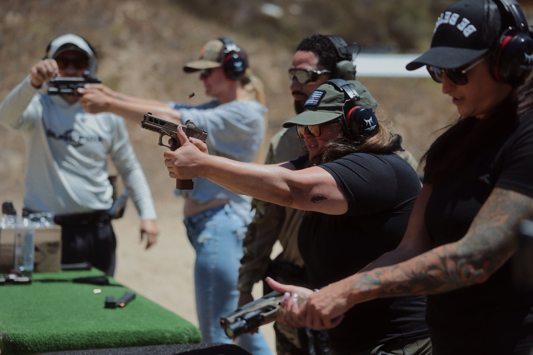Attendees receiving supervised pistol training at the No Sympathy Weekend range